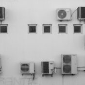 Black and white image of air conditioners mounted on a building facade in Córdoba, Argentina.