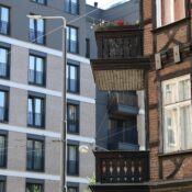 A juxtaposition of modern and historic buildings in a cityscape, highlighting urban contrasts.