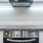 A sleek, modern kitchen with steel appliances and minimalist design.