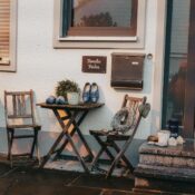 Charming entrance in Baiern, Germany with rustic chairs, table, and decorative elements.