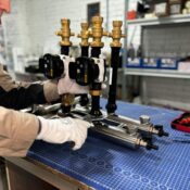 Engineer assembling a piping system for industrial heating, featuring valves and control units.