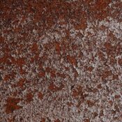 Close-up of a textured rusty metal surface, ideal for backgrounds or industrial themes.