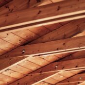Close-up of a rustic wooden ceiling with exposed beams and natural wood texture.