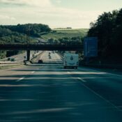 A scenic highway drive through the lush German countryside with a clear blue sky and summer vibe.