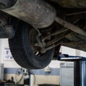 Close-up of car's undercarriage in a service station for repair and maintenance.