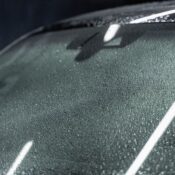 Detailed focus on a car windshield with raindrops, highlighting texture and refraction.