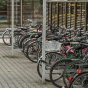 Bicycles parked in an outdoor urban lot in Wrocław, Poland.
