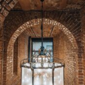 Rustic brick corridor featuring a vintage chandelier in İstanbul, Türkiye.