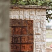 A detailed view of a vintage brick wall with carvings, perfect for urban and architectural themes.