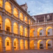 Beautiful Renaissance courtyard with arcades in Landhaus, Graz, Austria, lit by golden lights at dusk.