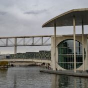 Modern architectural structures along the River Spree in Berlin, Germany, showcasing urban design.