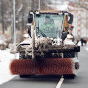 A snowplow operates during heavy snowfall, clearing roads in Jönköping, Sweden.