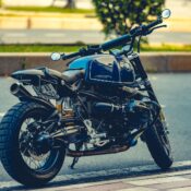 Stylish motorcycle parked on an urban road with natural background.