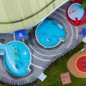 Vibrant aerial shot of a colorful outdoor water park with slides and pools.