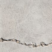 Close-up view of a cracked concrete surface with distinct textures in Logan, Utah.