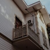 Low angle view of a classic Ottoman-style building facade with balcony in Istanbul, Turkey.