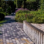 A picturesque stone pathway winding through lush greenery in Coesfeld, captured on a sunny summer day.