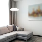 Elegant modern living room featuring a comfortable gray sofa, soft lighting, and minimalist decor.