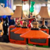 Colorful vintage lamps and retro TVs on display at a bustling Istanbul market.